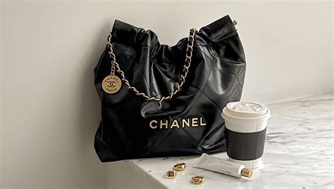 black chanel handbag with white logo|chanel 22 large bag.